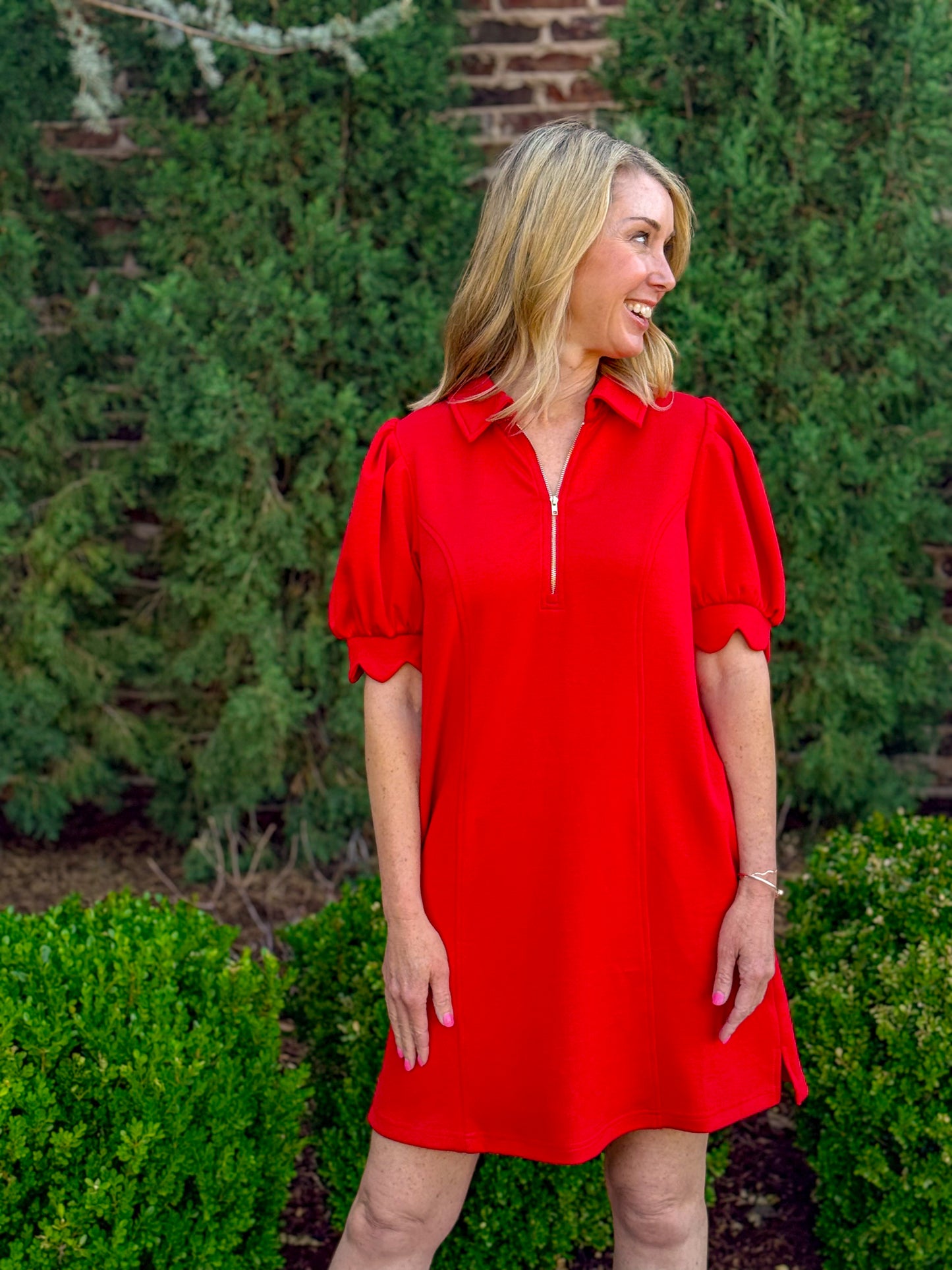 Side view of red puff sleeve dress with scalloped sleeve detail and easy fit