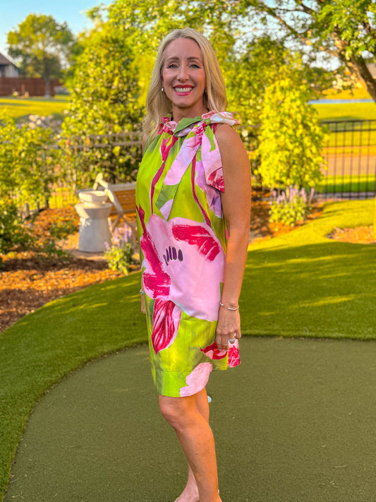 Green and pink floral halter mini dress with tie neck detail and relaxed fit shown at an angle