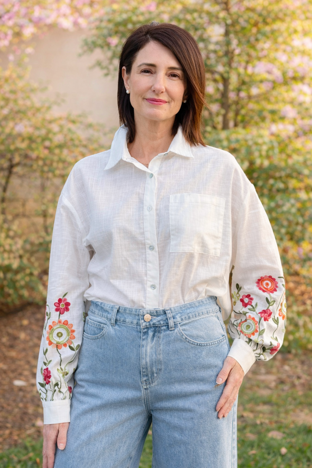 white cotton button down blouse with colorful floral embroidered sleeves loose fit women’s boutique top