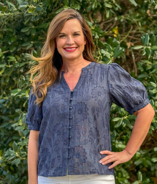 Navy floral textured blouse with puff sleeves and button front detail styled for women’s boutique fashion