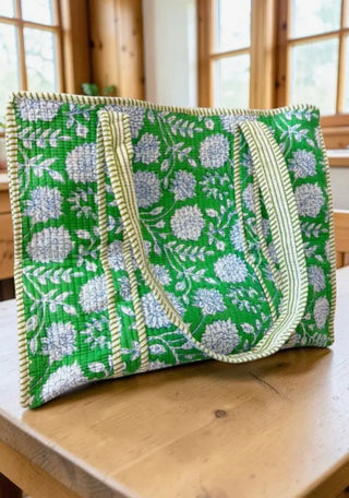 Kelly green floral quilted tote bag with white flowers and striped handles, spacious everyday carryall with interior pocket