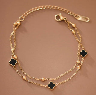 18K gold plated stainless steel layered chain bracelet with black clover accents and delicate gold bead details.