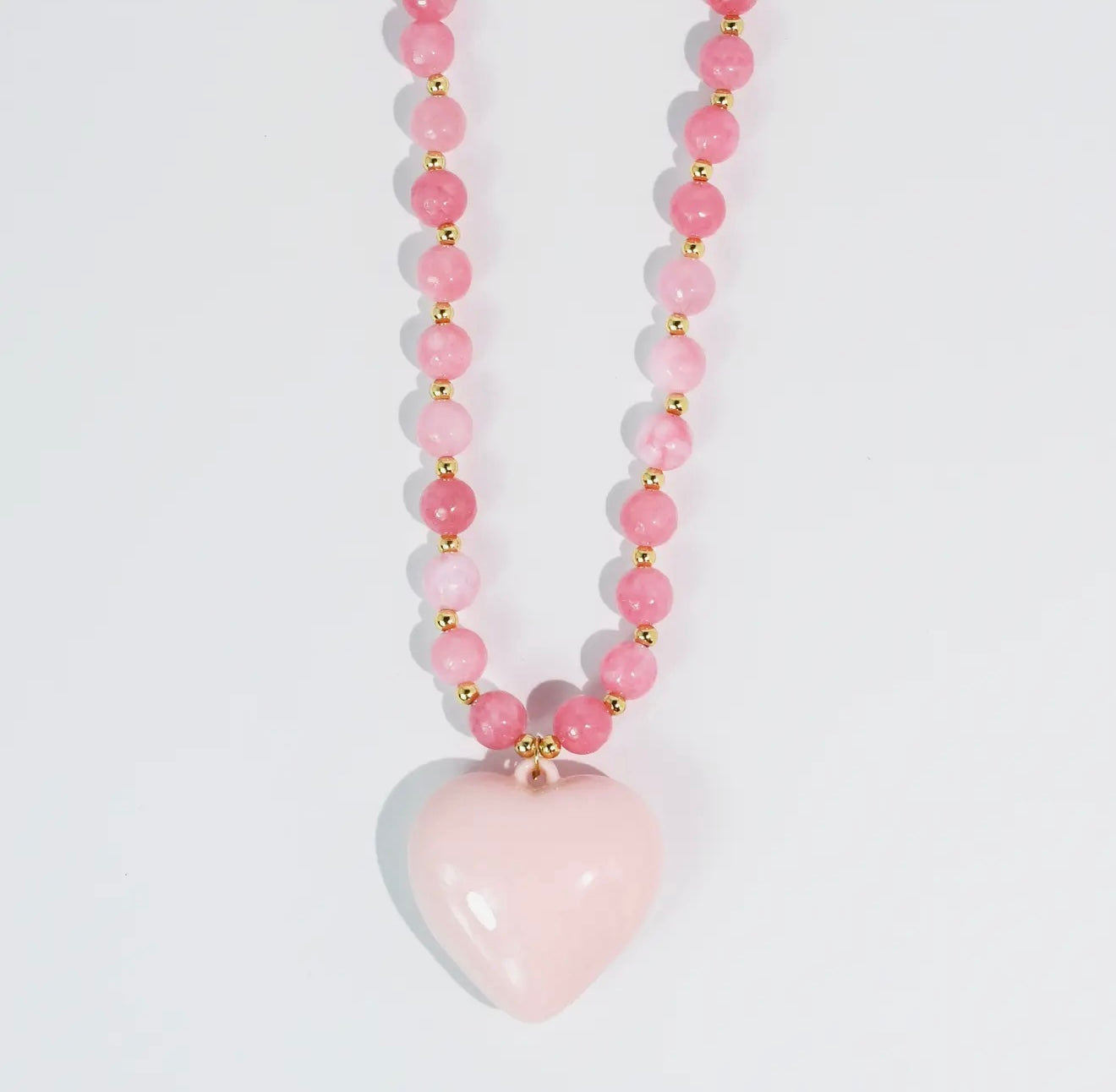 pink beaded necklace with glossy heart pendant