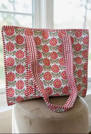Pink floral quilted tote bag with striped handles and spacious interior featuring an inside pocket. Oversized cotton tote for travel, beach days, and everyday use from Whimsical Mimsy Boutique.