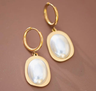 18K gold plated pearl drop hoop earrings with oval pearl detail on neutral background.