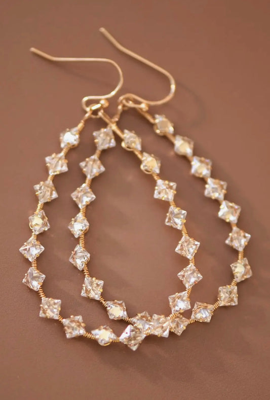wire wrapped zircon crystal teardrop dangle earrings with gold beaded design