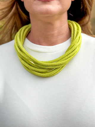 Lime green multi-strand statement necklace on white top, lightweight layered cord necklace for women’s boutique styling