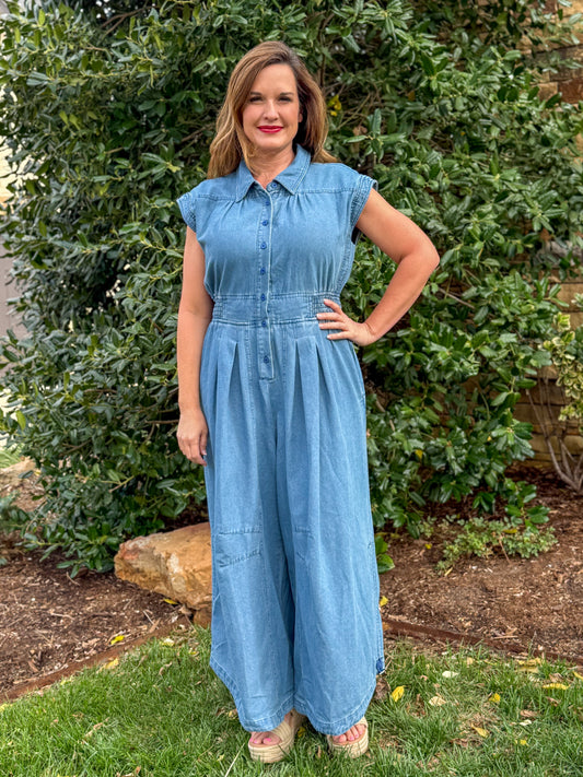 Chambray denim wide leg jumpsuit with button front, cap sleeves, and elastic waist styled for women’s casual boutique fashion